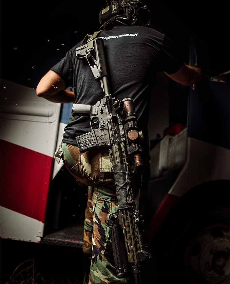 UIC MOD2 18" Special Purpose Rifle SPR being carried on back while getting into vehicle